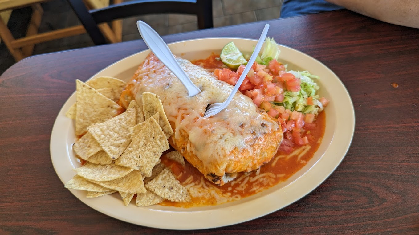 Smothered burrito plate with chips, pico de gallo, and guacamole
